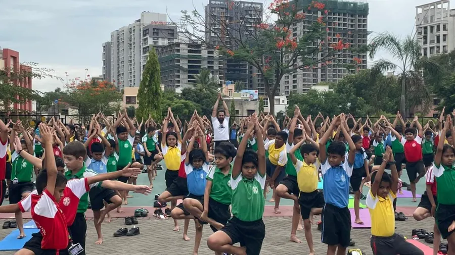 Students practising yoga together on the school grounds